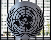the united nations emblem is on display in front of a window