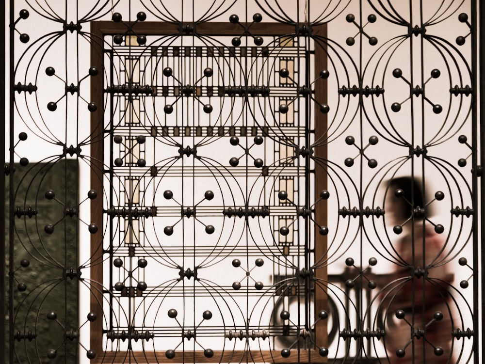 a close up of a metal gate with circles on it
