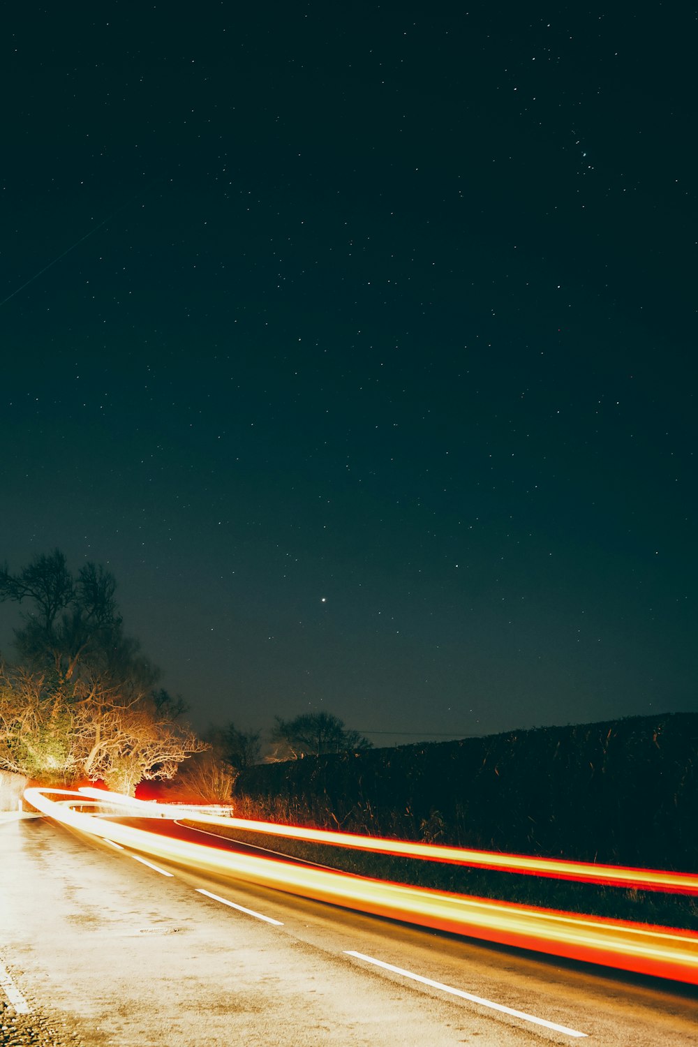 a long exposure photo of a street at night