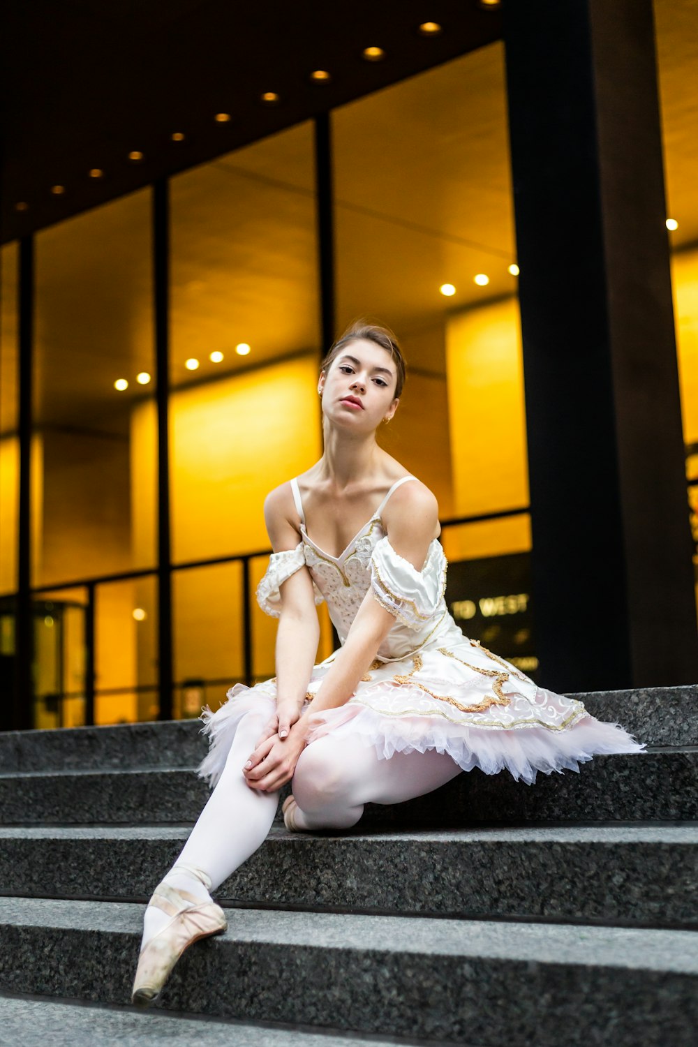 a ballerina sitting on the steps of a building