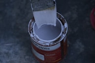 a paint can with a brush inside of it