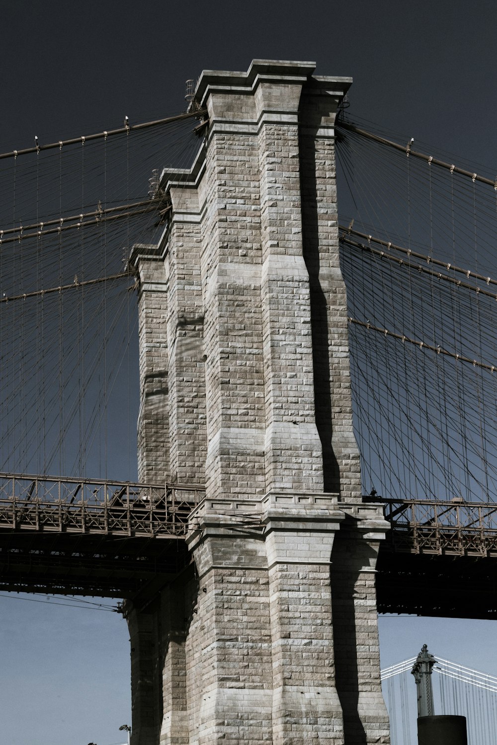 a clock tower with a bridge in the background