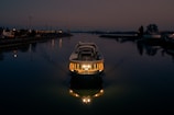 Elegant private boat gliding along the river with warm sunset tones reflecting on the water.