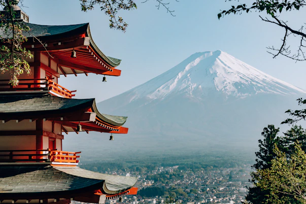 a view of a mountain with pagodas in front of it