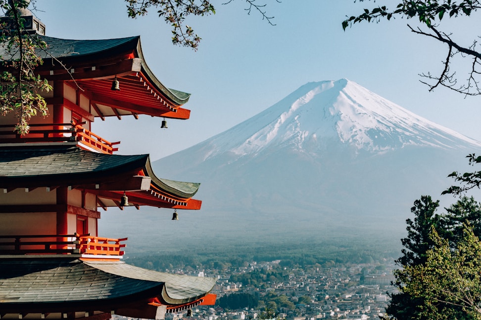 a view of a mountain with pagodas in front of it