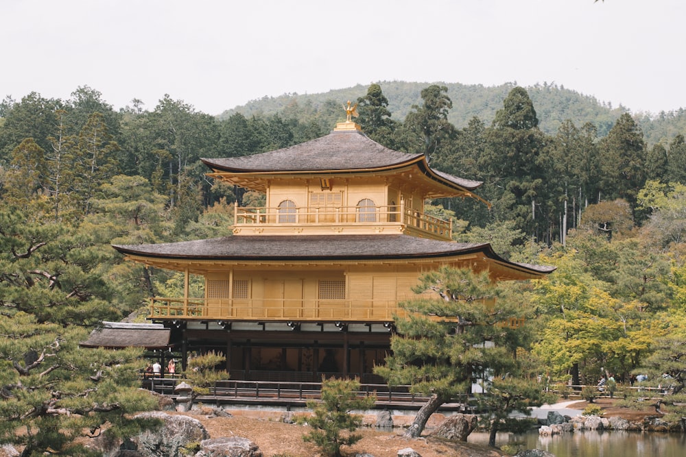 a tall yellow building sitting in the middle of a forest