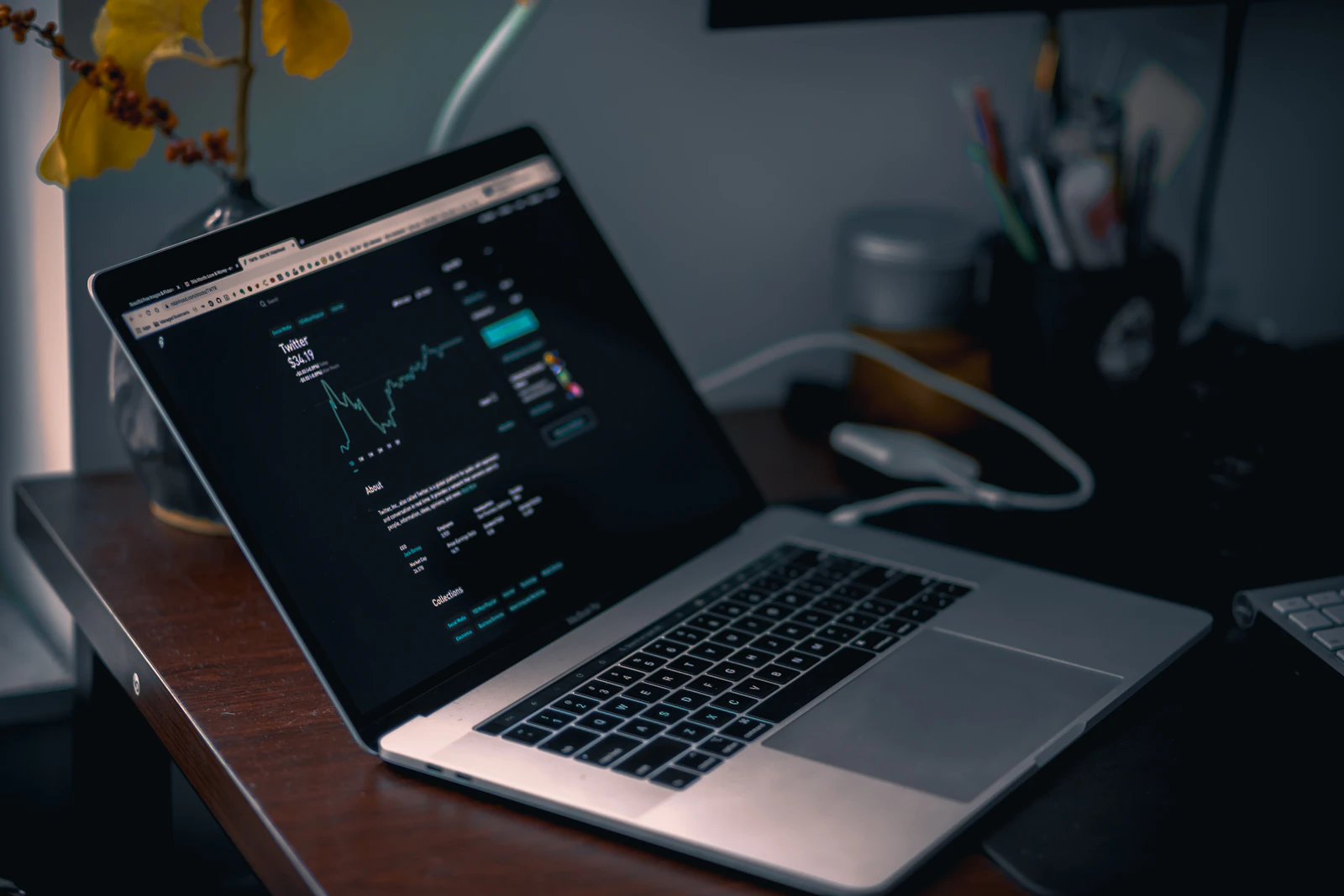 Laptop displaying a stock-market chart in a focused workspace