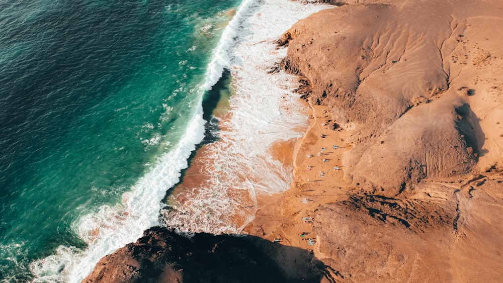 an aerial view of a sandy beach and ocean