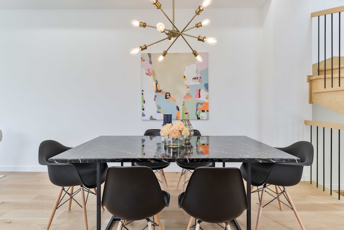 A modern dining room set with stylish chairs and a table.