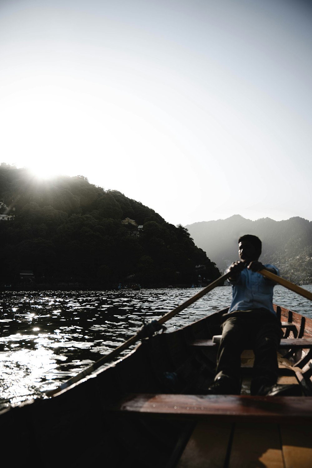 a man sitting in a boat on a body of water
