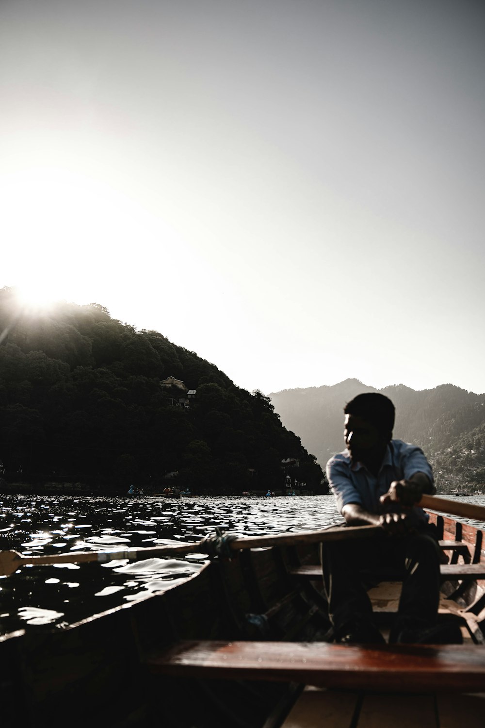 a man is sitting on a boat in the water