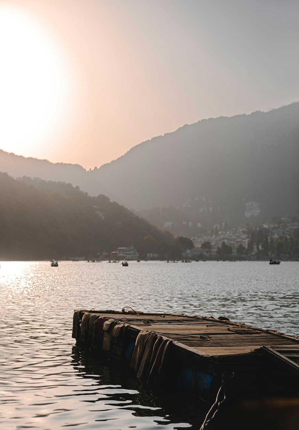 a row of boats floating on top of a lake