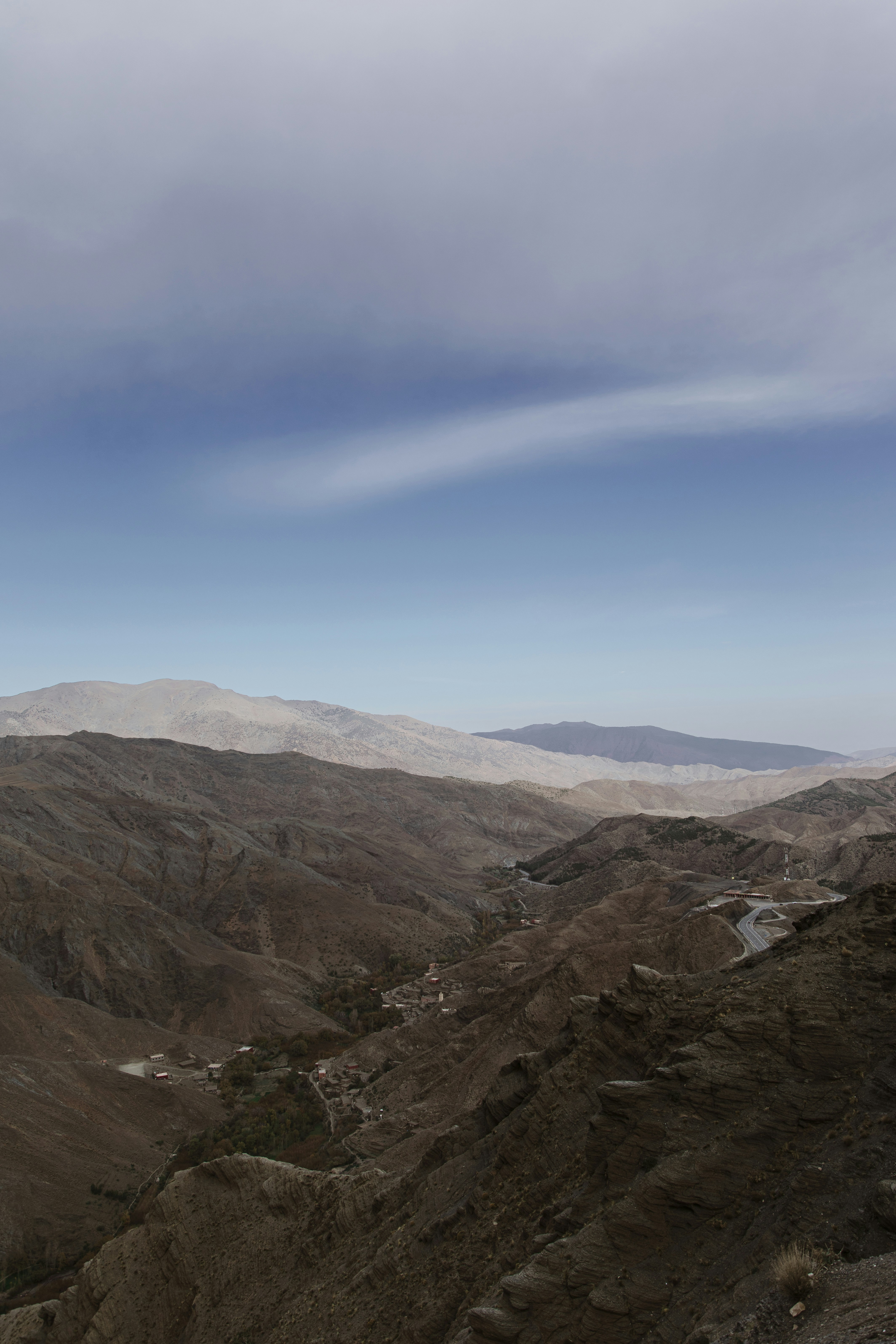 a view of a valley with mountains in the background