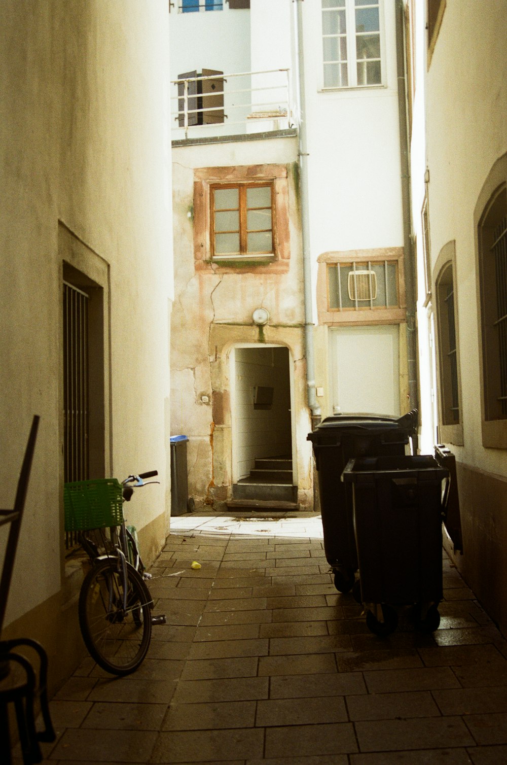 a narrow alleyway with a bicycle parked on the side
