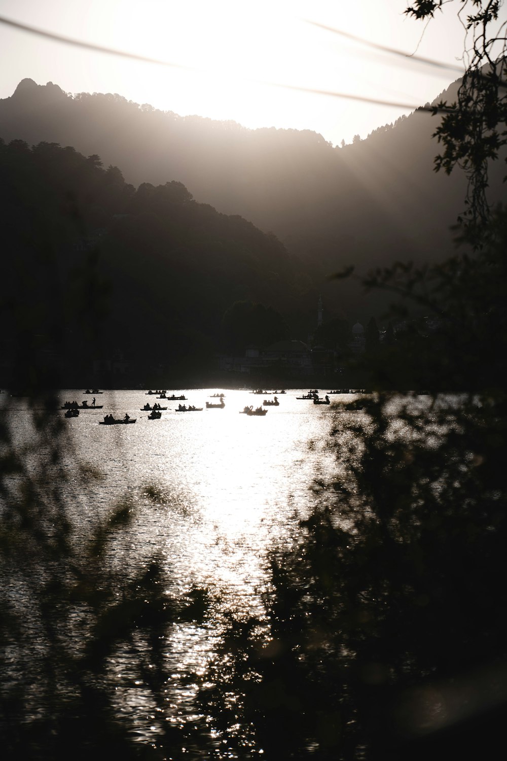 a group of boats floating on top of a lake