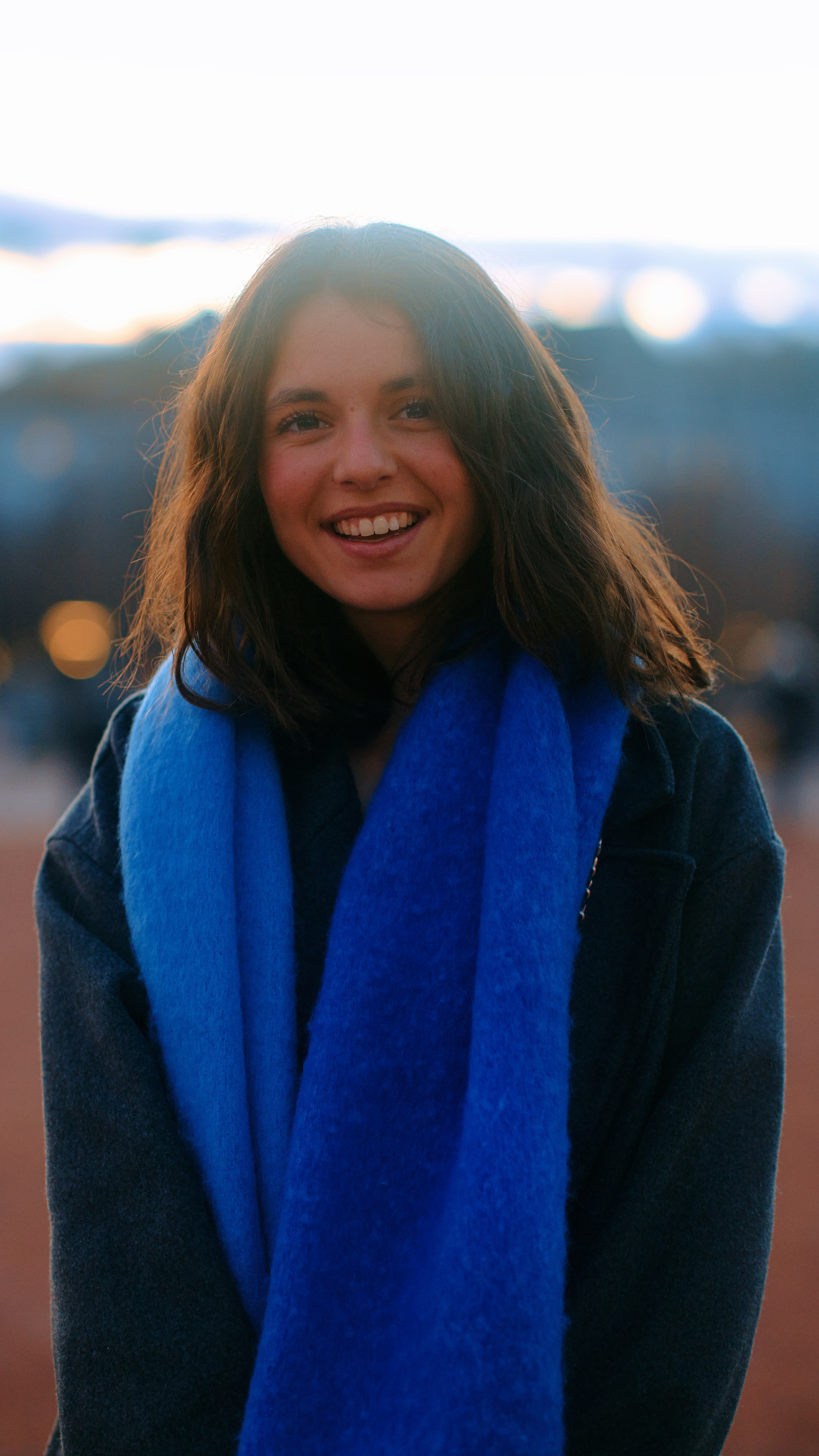 A woman with a blue scarf around her neck photo – Free Image on Unsplash