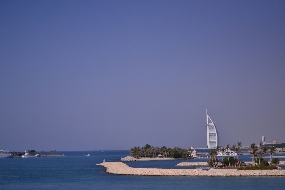 a view of a beach with a tall building in the background
