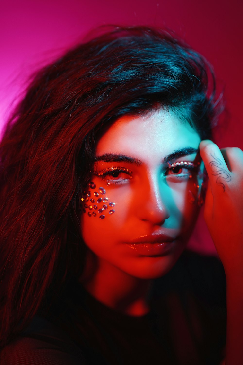 a woman with makeup on her face and a red background