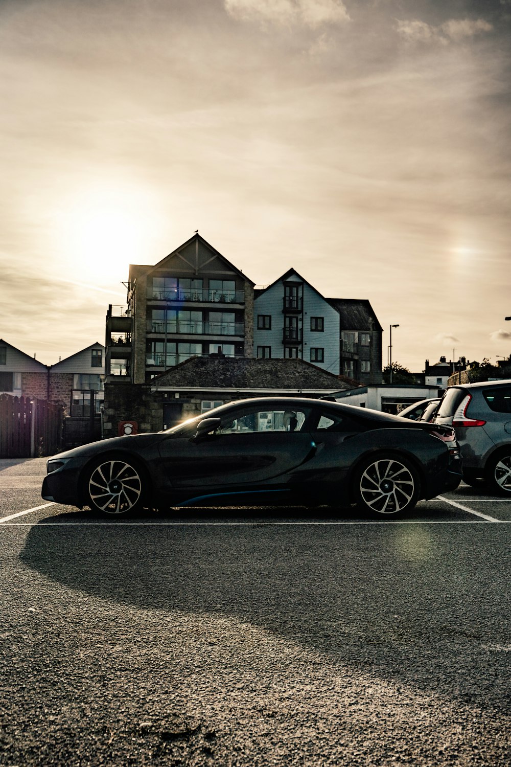 a black sports car parked in a parking lot