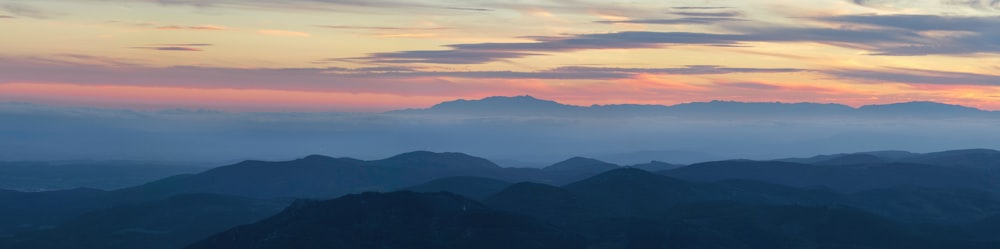 a view of a mountain range at sunset