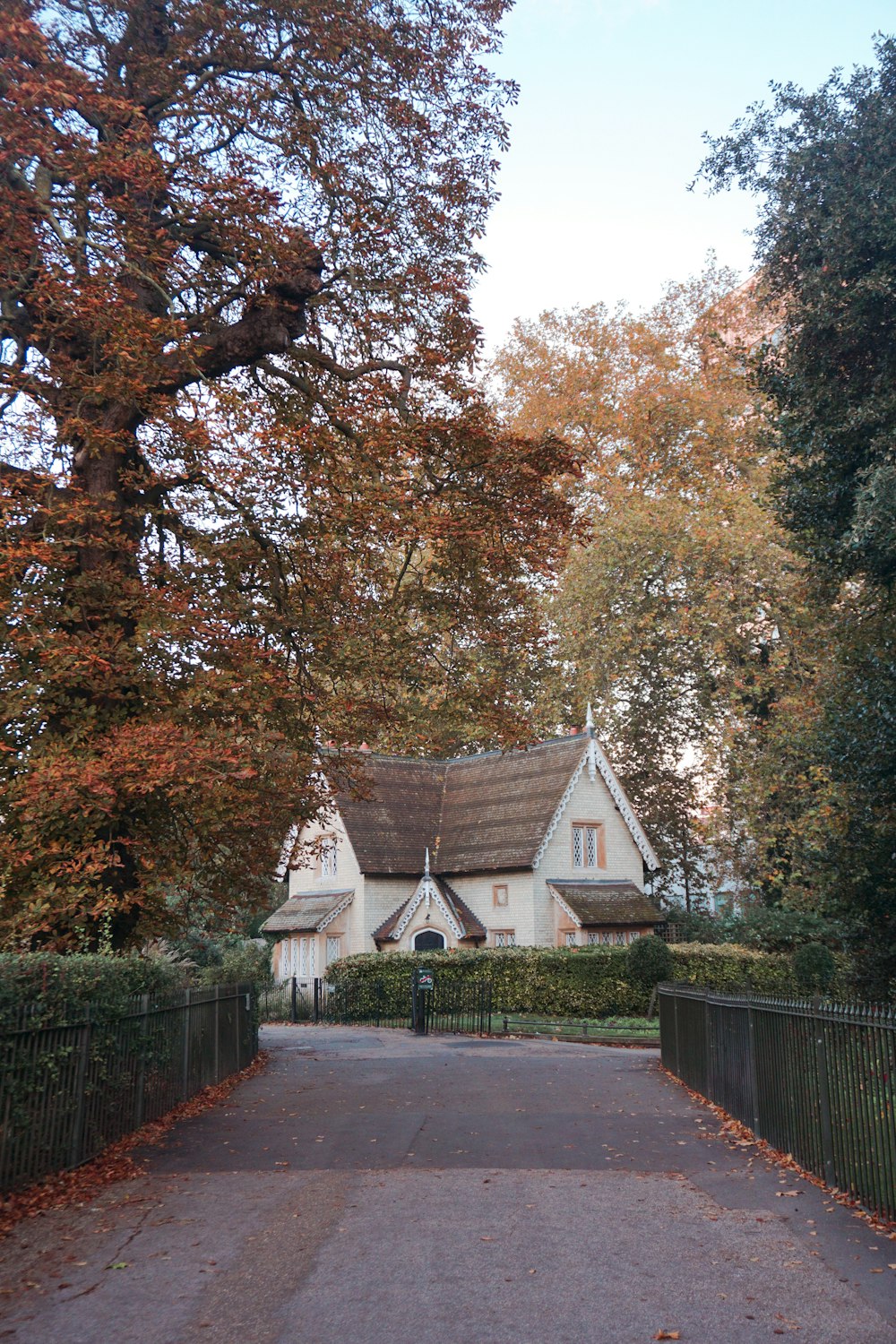 a white house with a brown roof surrounded by trees