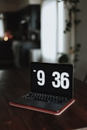 a laptop computer sitting on top of a wooden table