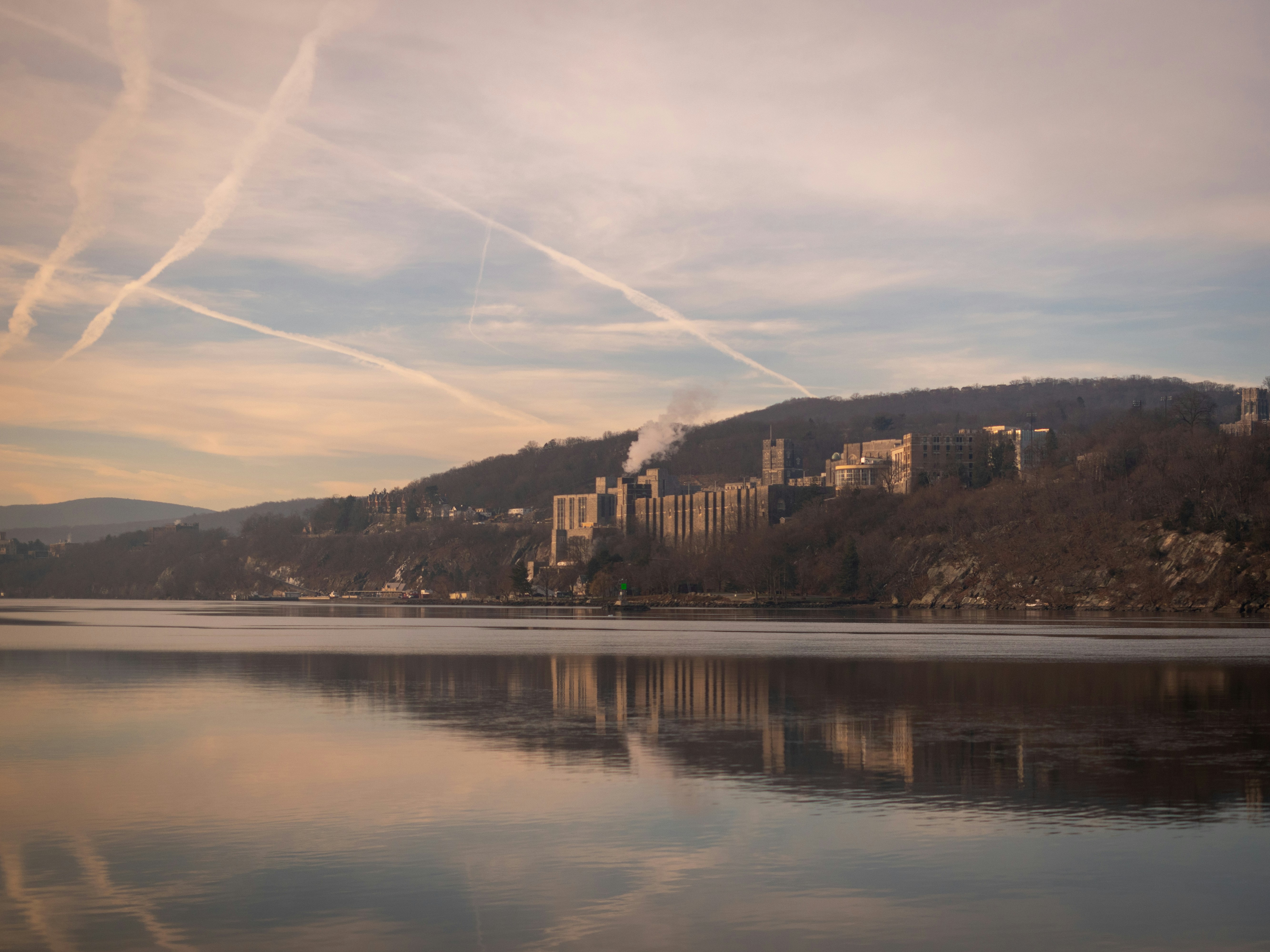 a body of water with a city in the background
