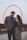 a man and a woman standing in front of a ferris wheel