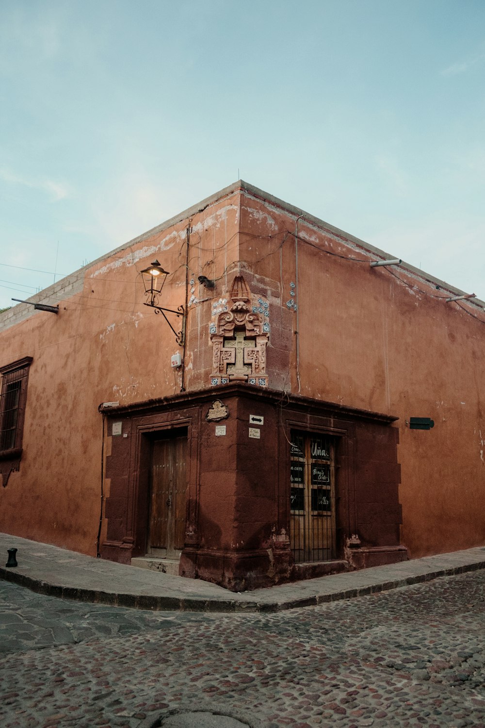 a brown building with a clock on the side of it