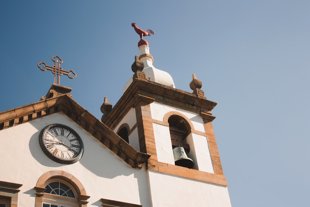 a church steeple with a bell and a clock