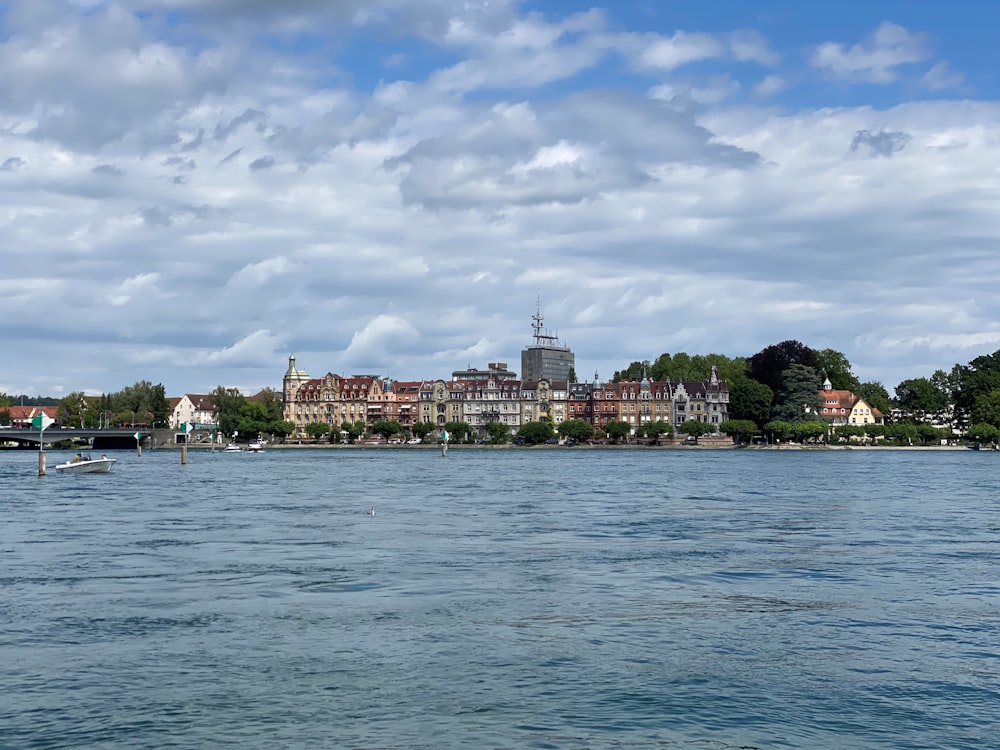 a large body of water with buildings in the background