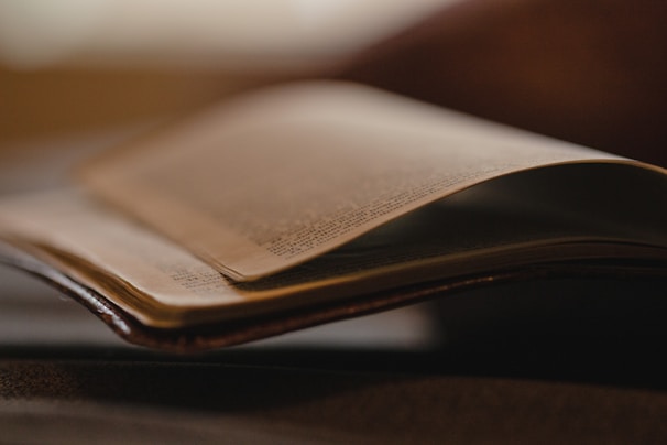 A close-up of an open book with soft lighting.