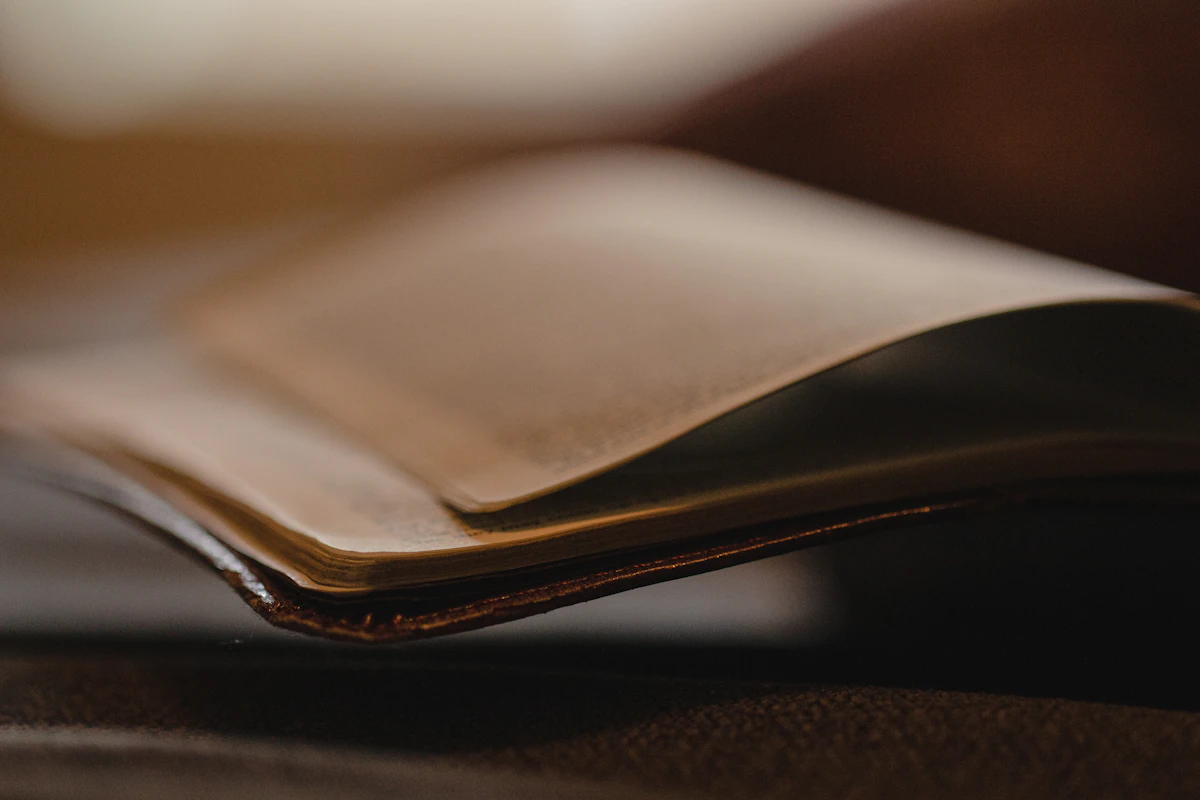 Open leather-bound Bible resting on a pew
