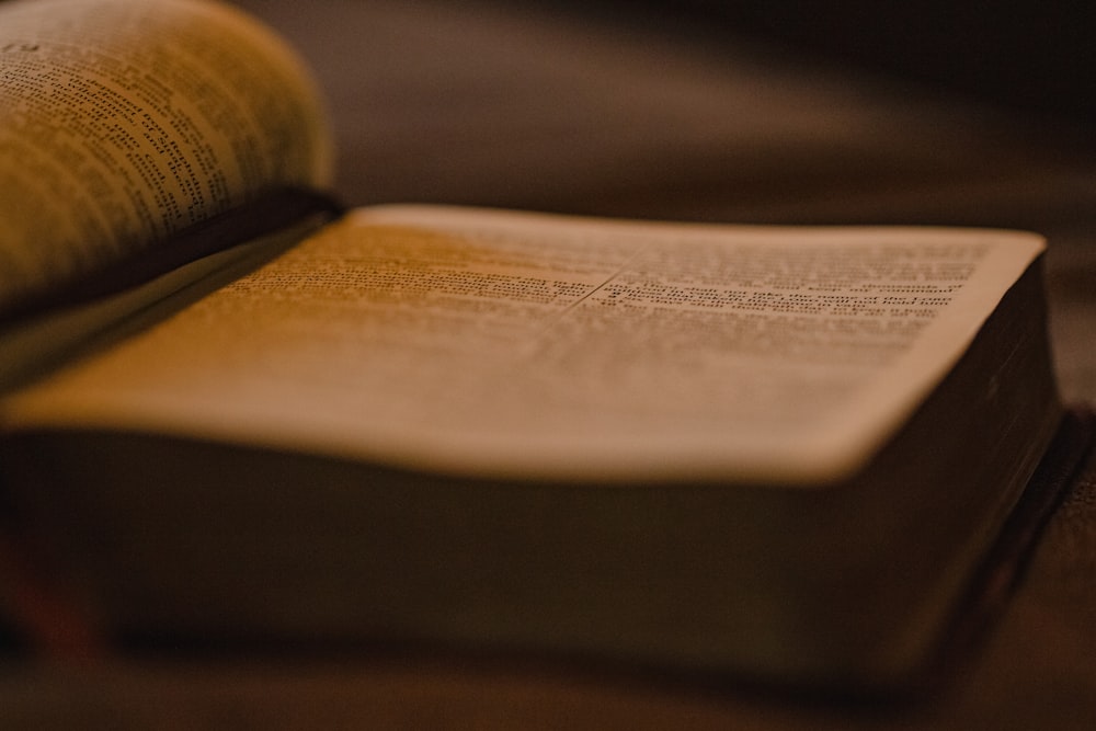 an open book sitting on top of a wooden table