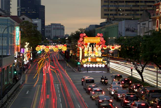 a city street filled with lots of traffic next to tall buildings