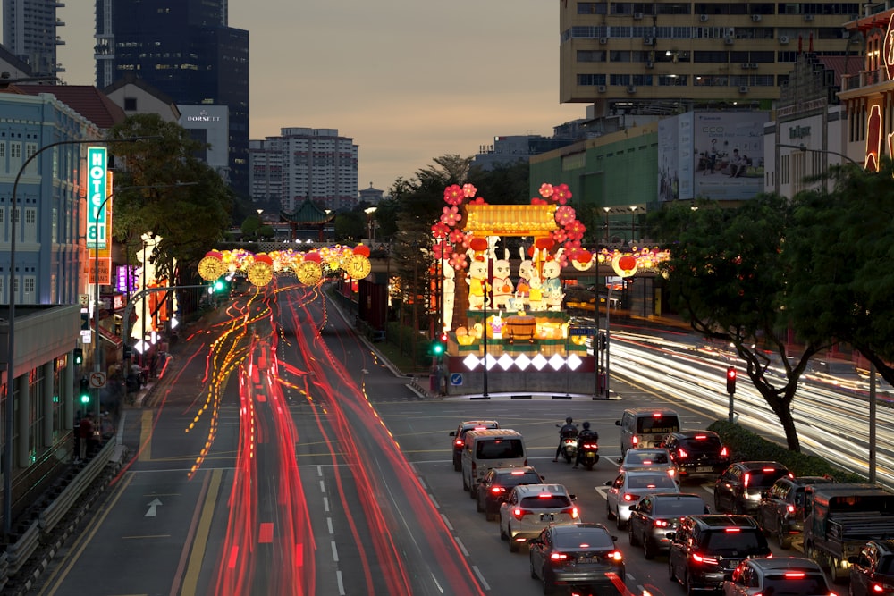 a city street filled with lots of traffic next to tall buildings