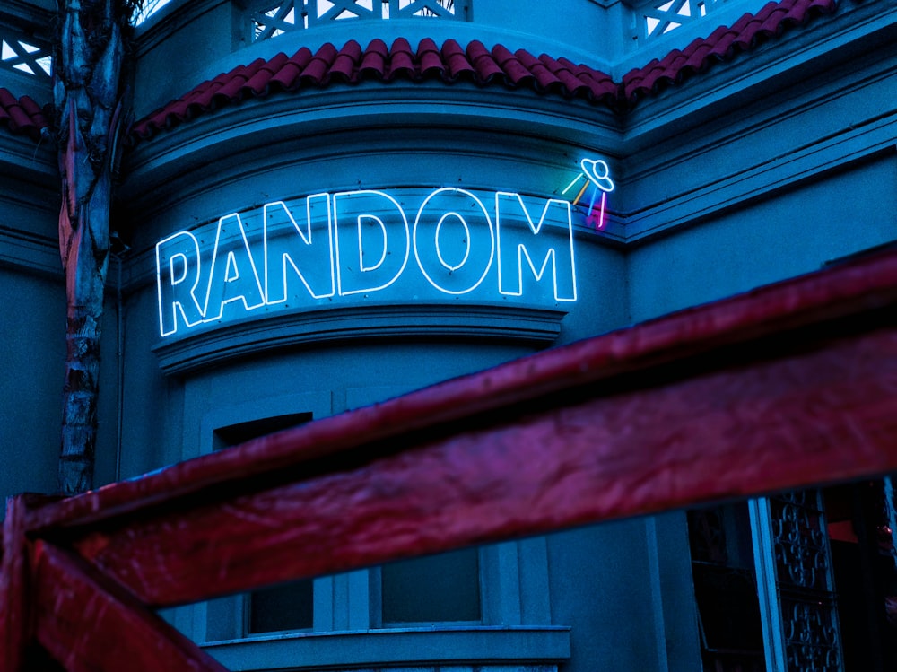 a building with a neon sign that reads random