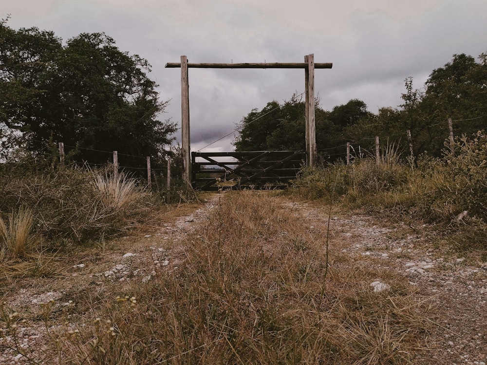 a gate in the middle of a dirt road