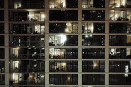 A friendly real estate agent showing a family around a bright, spacious apartment.