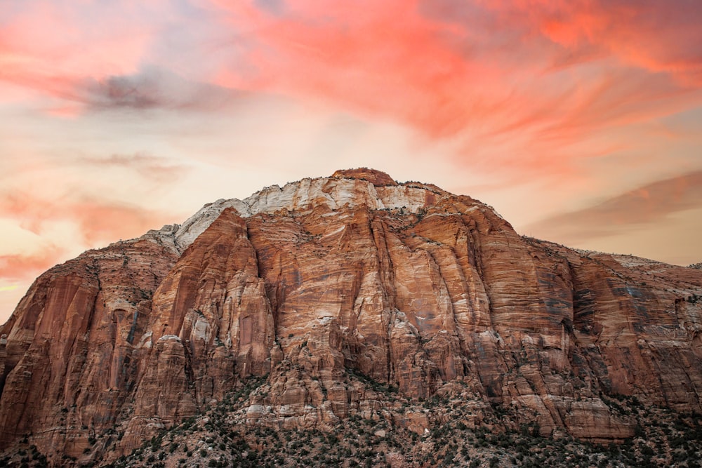 a mountain with a red sky in the background