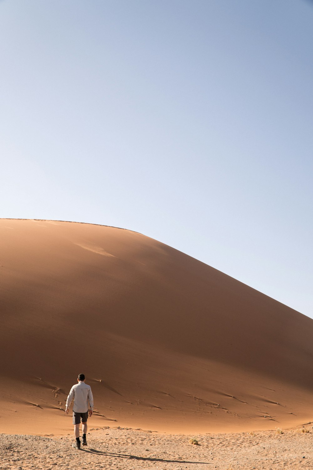 a man standing in the middle of a desert