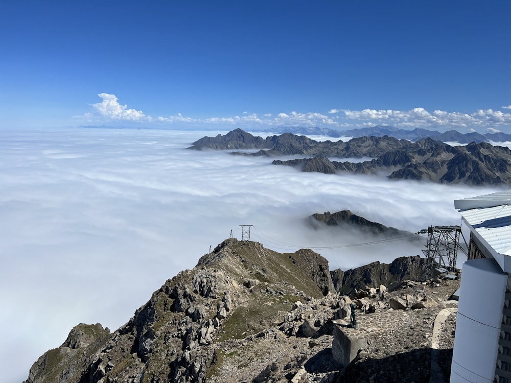 a view of a mountain range with clouds in the foreground