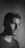 Studio shot with dramatic lighting highlighting a thoughtful man in monochrome.