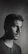 Studio shot with dramatic lighting highlighting a thoughtful man in monochrome.