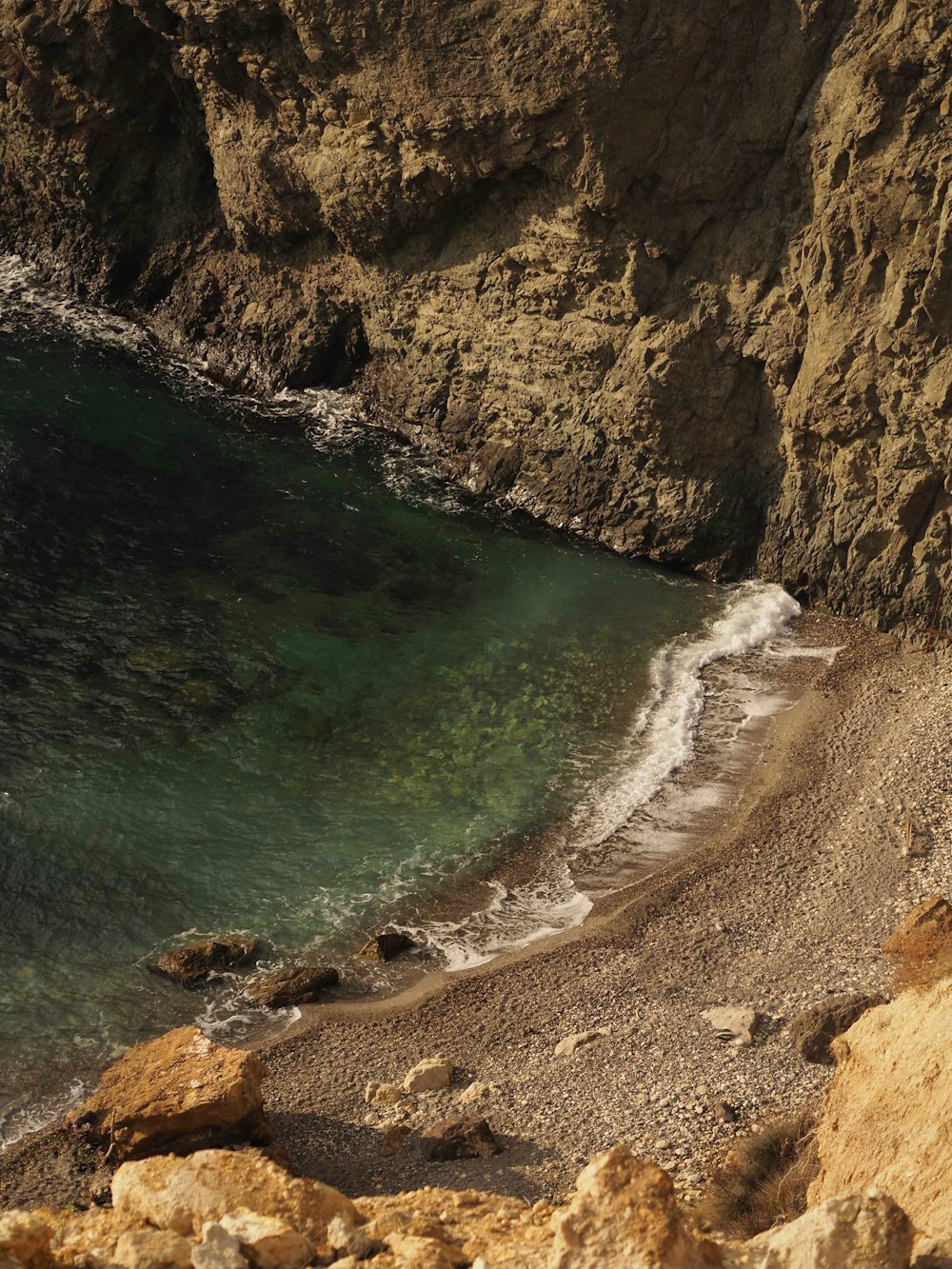 a view of the ocean from a rocky cliff