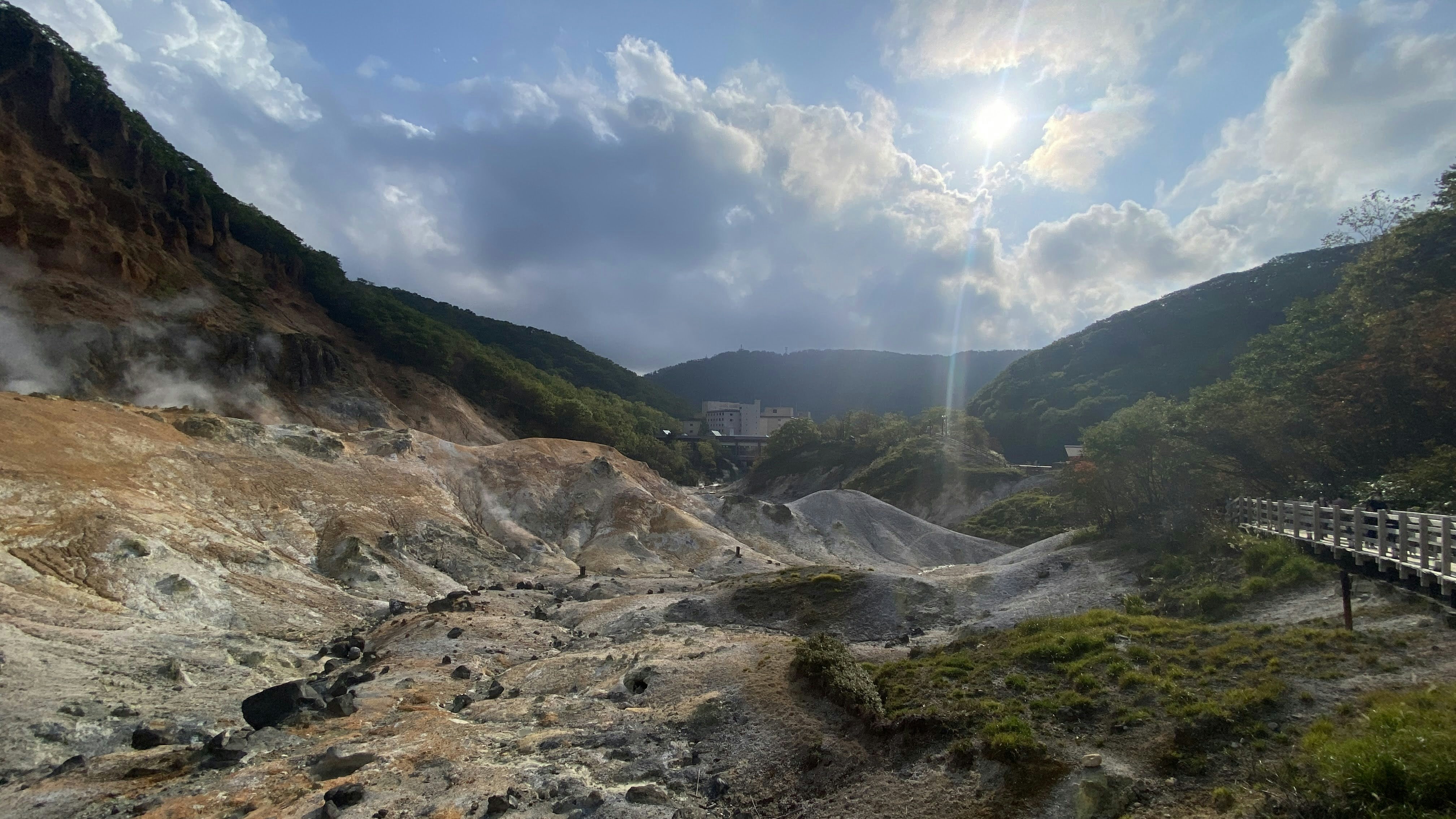 Volcanic sulphurous valley with steaming vents and otherworldly rocky landscape in tropical setting