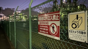 Electric fence with concertina wire securing a commercial property at dusk