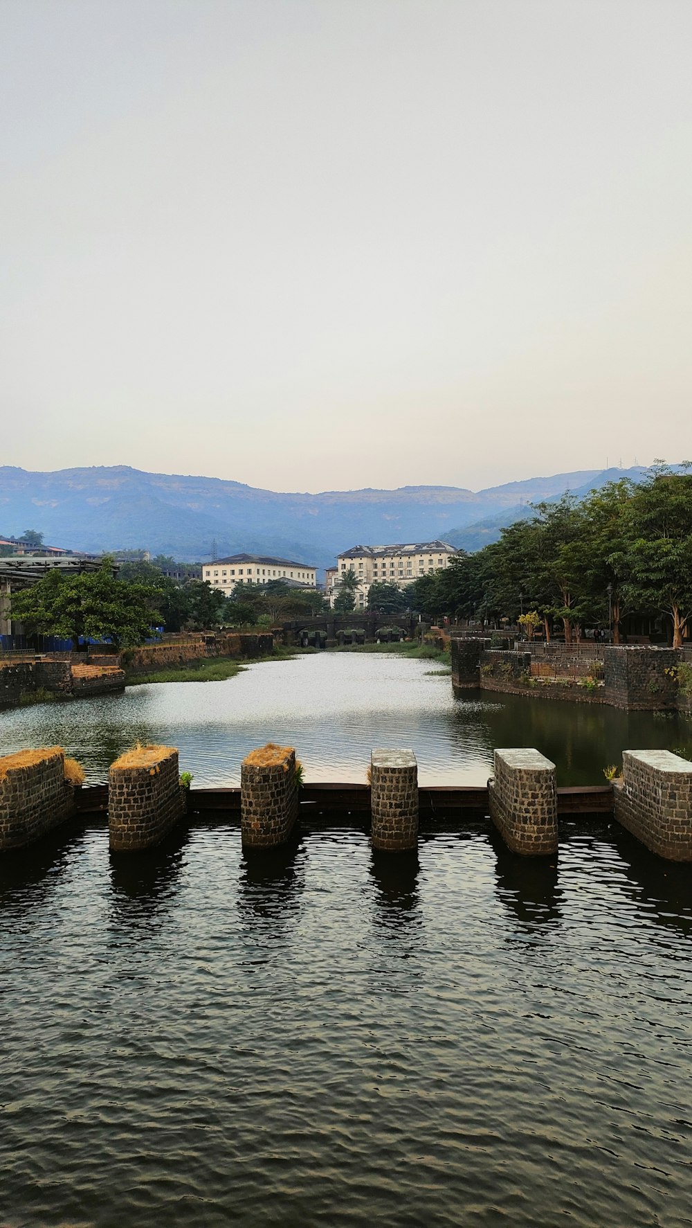 a large body of water surrounded by stone pillars