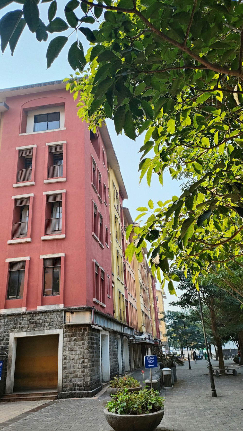 a tall red building sitting on the side of a street