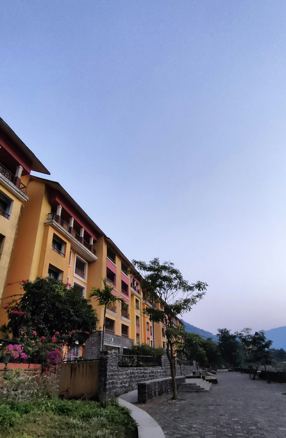 a large yellow building with several balconies on top of it